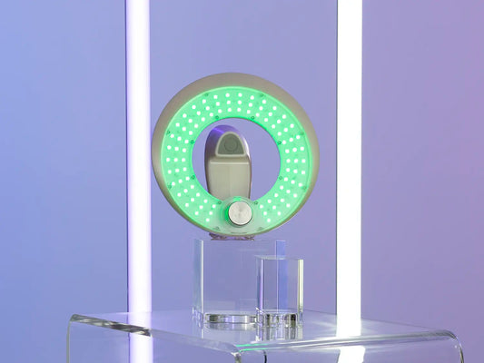 A MMSphere LED light therapy device set to a green setting is on display.